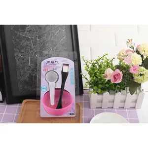 Detail view of DIY face mask tool kit with pink bowl and dual-use brush in retail packaging
