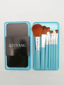 Set of 7 makeup brushes with blue handles in a translucent storage case