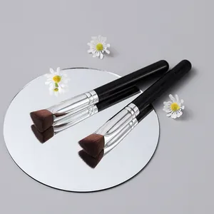 Professional angled makeup brush for highlighter and concealer on a mirror background