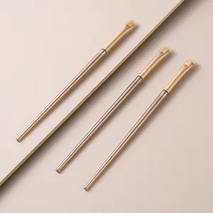 Close-up of three professional crescent-shaped makeup brushes for precise eye detail application