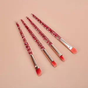 Professionele make-upborstelset met transparante handvatten en rode glitterdetails.