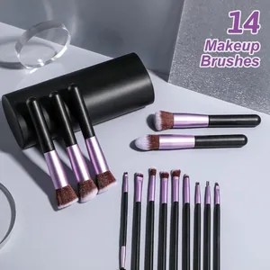 Set di 14 pennelli da trucco viola uva con setole morbide e custodia cilindrica nera.