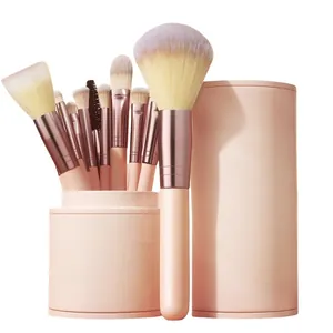 Professional 12-piece pink makeup brush set with cylindrical case for powder and eyeshadow.