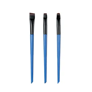 Detailed view of three precision makeup brushes with blue handles on white background