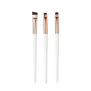Detail shot of three fine eyeliner and concealer brushes with rose gold ferrules.