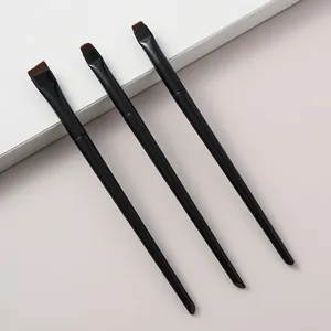 Detail view of three precision eyeliner and eye detail makeup brushes with black handles