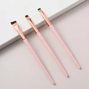 Detail view of three pink precision makeup brushes for eyeliner, concealer and shadow
