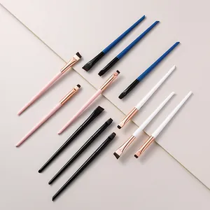 Detailed view of professional makeup brushes in pink blue white and black colors