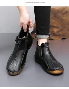 Detail view of men's black mid-cut casual leather shoes with contrast stitching