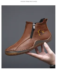 Detail view of brown leather mid-top casual shoe with side zipper and stitched sole.