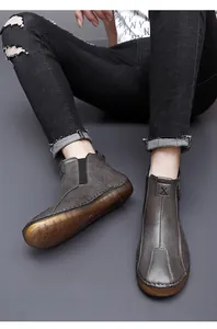 Detailed view of grey mid-top casual shoes with zipper and elastic panel