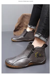 Detail of grey leather mid-top casual shoes for men with side zipper and durable sole.