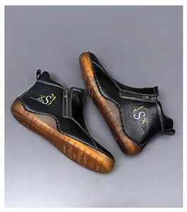 Detailed view of men's black mid-top casual shoes with side zipper and gum sole