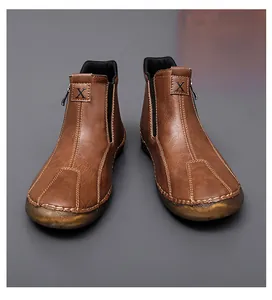 Close-up view of brown mid-top casual shoes with leather texture and detailed 'X' logo