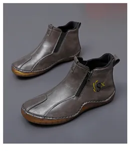 Detail of men's casual mid-top boots with side zipper and textured finish