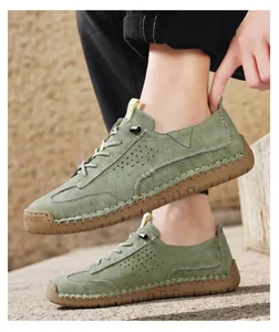 Close-up detail of olive green casual hand-stitched leather shoes with durable rubber soles