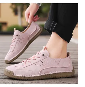Detailed view of pink suede casual shoes featuring hand-stitched sole and breathable holes