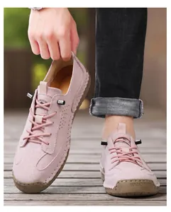 Close-up detail of pink handmade stitched leather casual moccasins with AUS lace lock