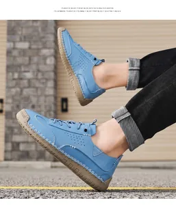 Detailed side view of blue casual loafers featuring hand-stitched detailing and holes.