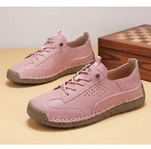 Premium pink leather casual shoes featuring unique hand-stitched detailing and breathable side perforations.