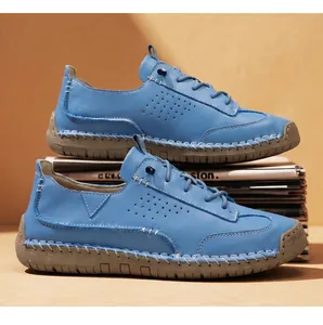 Detailed view of blue leather casual shoes featuring hand-stitched accents and soft rubber soles