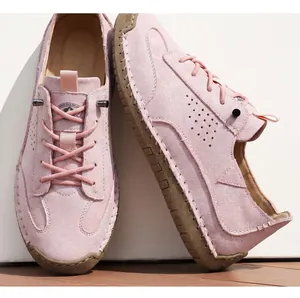 Close-up of pink casual leather loafers with hand-stitched detailing and laces