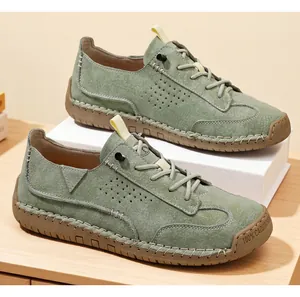 Close-up of sage green casual loafers with textured leather and hand-stitched detailing