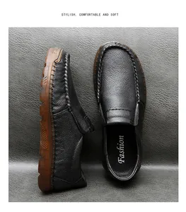 Close-up of black textured leather loafers with durable brown rubber soles