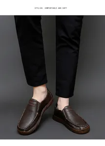 Detail view of men's brown leather loafers showing intricate stitching and soft grain texture