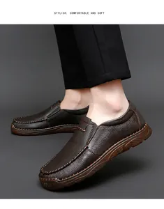 Detail of men's brown leather loafers showing soft texture and contrast stitching