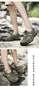 Close-up detail of men's green leather outdoor sandals with closed-toe design on rocks