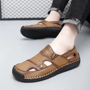 Men's brown breathable leather sandals with soft black soles for outdoor beach walking.