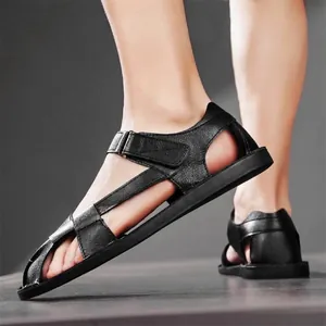 Classic men's black flat non-slip Roman leather sandals shown in a professional studio setting