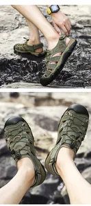 Detailed close-up of men's olive green closed-toe outdoor sandals on a rocky riverbed