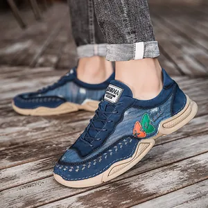 Men's blue denim casual lace-up sneakers featuring a thick beige sole and decorative stitching