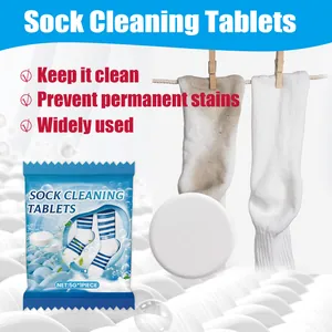 Close-up of sock cleaning tablet and packaging with before and after laundry comparison.