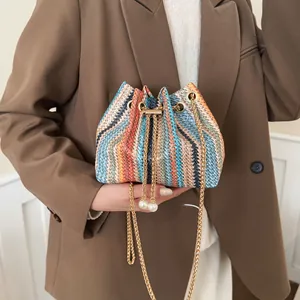 Colorful rainbow woven bucket bag for women with gold chain strap and pearl charms.