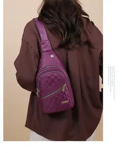 Back view of a model wearing a stylish purple quilted nylon sling bag for women