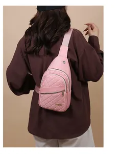 Detailed view of a pink quilted sling bag for women showing fine texture and zippers