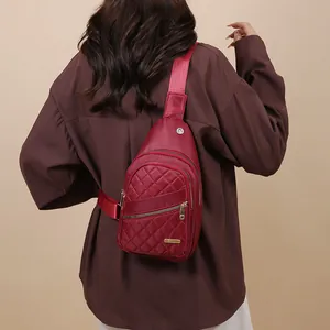 Stylish burgundy quilted chest bag for women worn by a model in a studio setting