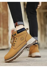Detailed close-up of classic tan premium leather Martin boots for men on the street