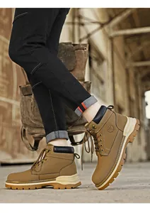 Close-up detail of stylish tan leather Martin boots worn in a rugged industrial setting