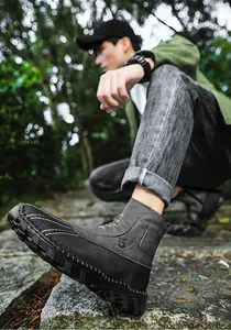 Detailed outdoor view of men's gray high-top casual boots with durable thick rubber soles