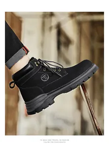Detailed view of men's black leather Martin boots with thick anti-slip rubber sole