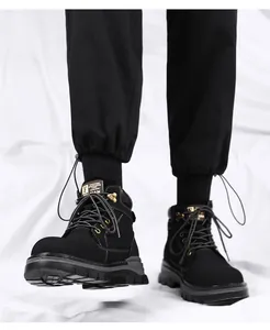 Detail shot of black high-top Martin boots with metallic eyelets and rugged sole