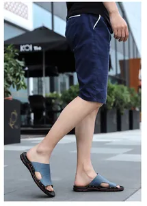 Detail shot of men's casual blue textured slides with studded sole and red accents