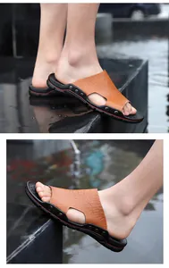 Detail view of men's brown crocodile texture slide sandals with anti-slip sole.