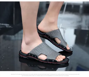 Close-up of men's casual grey crocodile pattern slide sandals on model's feet