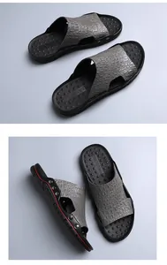 Detail of men's casual sandals featuring grey crocodile texture and black anti-slip soles