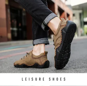 Detailed view of men's brown hand-stitched casual shoes being worn in an outdoor street setting